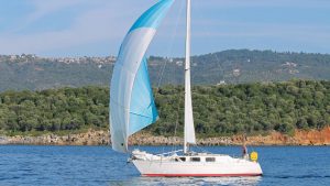 A yacht sailing past the Greek coastline