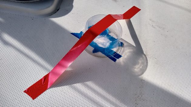 A empty plastic pot covering up a cracked gelcoat repair on a boat