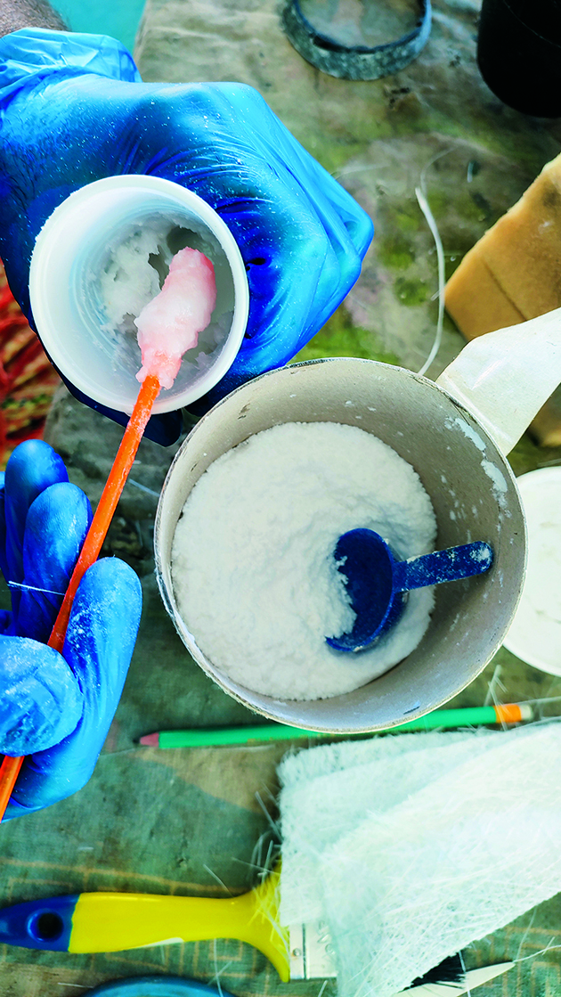 A person mixing microfibres for boat fibreglass repair