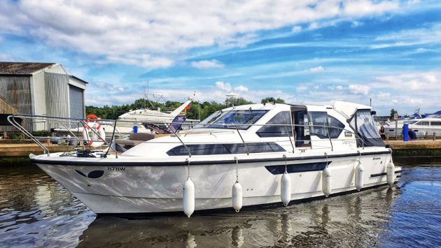 A Broom boats white boat on the water