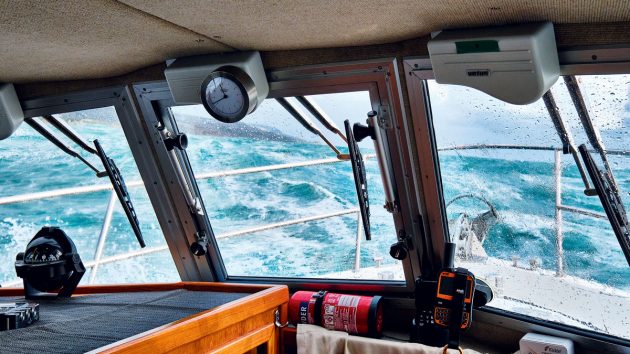 A man undertaking motorboat handling in rough weather