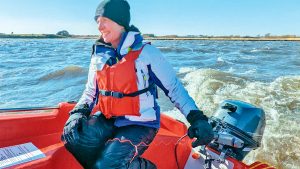 A woman driving an outboard motor