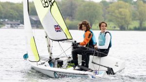 Young people sailing a dinghy