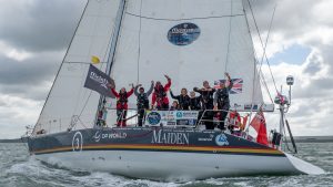 Crew waving from the deck of the 58ft yacht, Maiden
