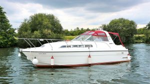 A white motorboat on a river