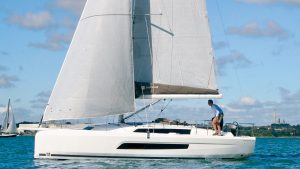 A man sailing a Dufour 37 yacht