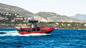 The Vita Power Seal RIB with red hull being driven off the coast