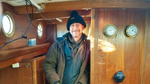 Russian sailor Roman Titov standing in his yacht