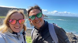 A man and a women wearing sunglasses