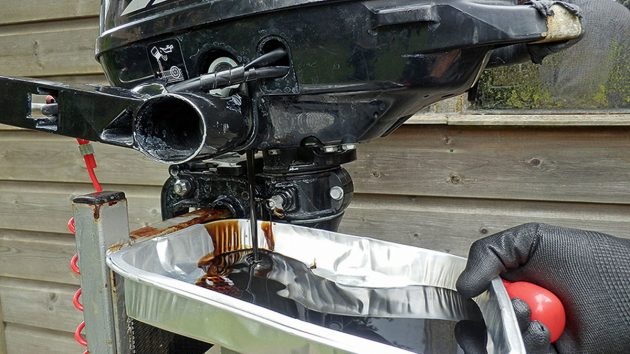 Oil being drained from an outboard motor