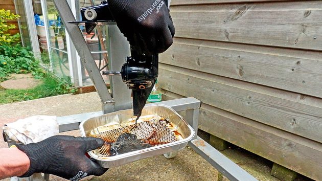 oil being drained from an outboard motor