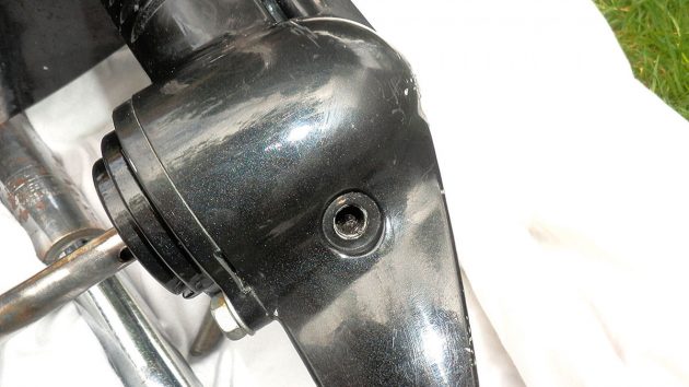 A drain plug hole on an outboard motor during an outboard motor gearbox replacement