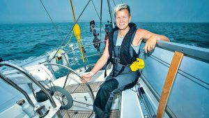 A woman solo sailing on a yacht