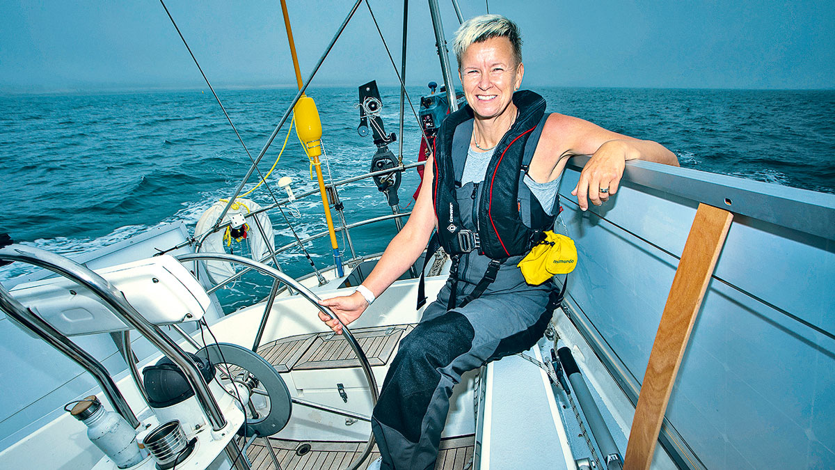 A woman solo sailing on a yacht