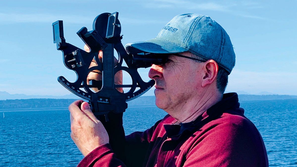 A man using a sextant for celestial navigation
