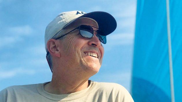 A man wearing sunglasses smiling