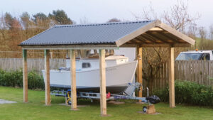 A boat under a boat port in a garden