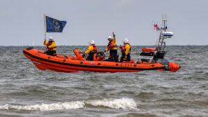 National Coastwatch Institution (NCI) flag relay at Brancaster with transport via a RNLI rigid inflatable boat
