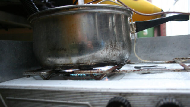 A pan being heated on a gas hob