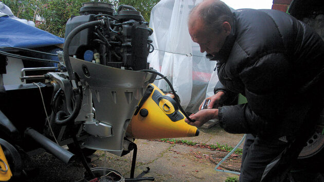 A man working on our outboard engine