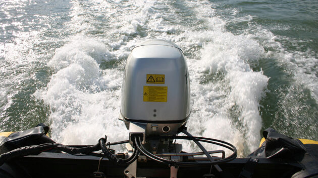 An outboard engine running on the back of a boat