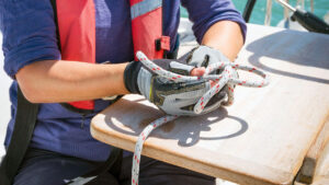A woman tying sailing knots on a boat
