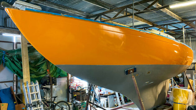 A boat with an orange hull