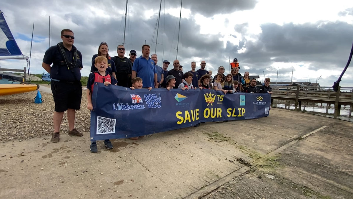 Southwold Sailing Club members with a Save Our Slip banner