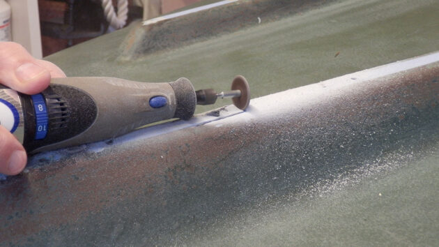 An abrasive disc being used to cut into a boat