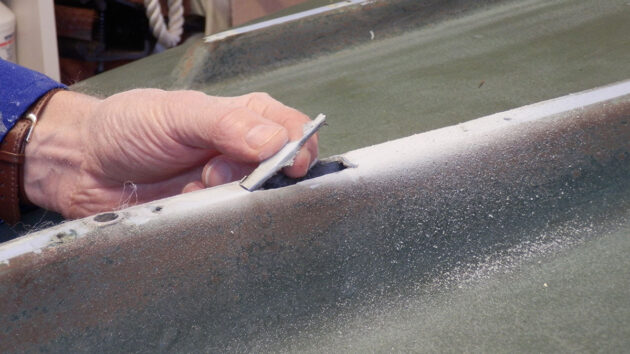 A damaged section of a keel being lifted from a boat