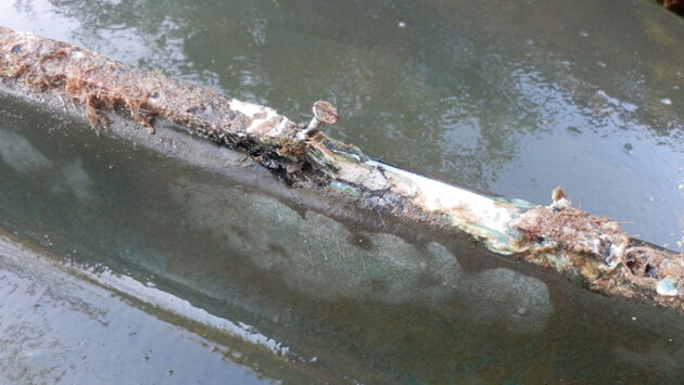 A protruding screw on the hull of a boat