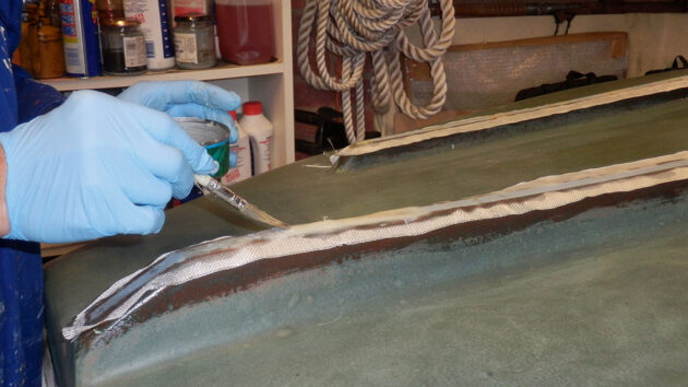 Woven glass tape being applied to a boat