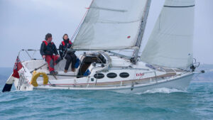 A couple sailing an Etap 24i boat