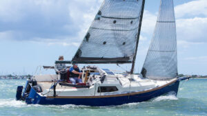 A Bay Cruiser 26 being sailed along the coast