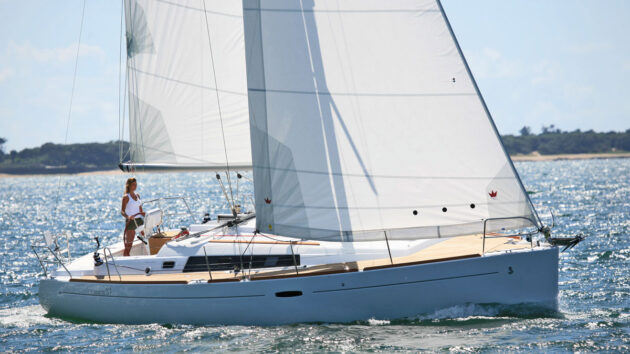 A woman sailing used Beneteau sailboats