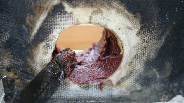 Epoxy being applied to a boat