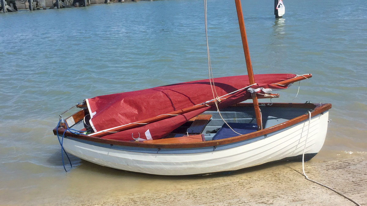An Emsworth Lugger boats pulled up on a beach