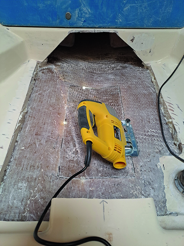 A hole being cut in a boat to fit a bow thruster