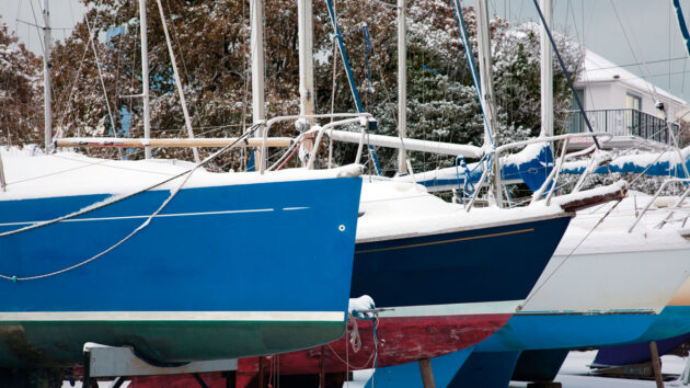 Boats in a yard in the snow