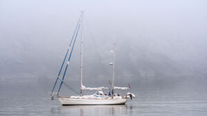 A yacht sailing in fog