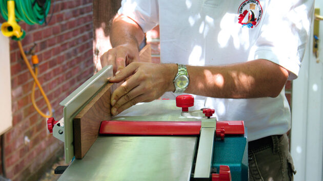 A man cutting wood