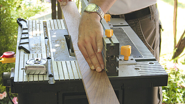 A man trimming wood for duck boards