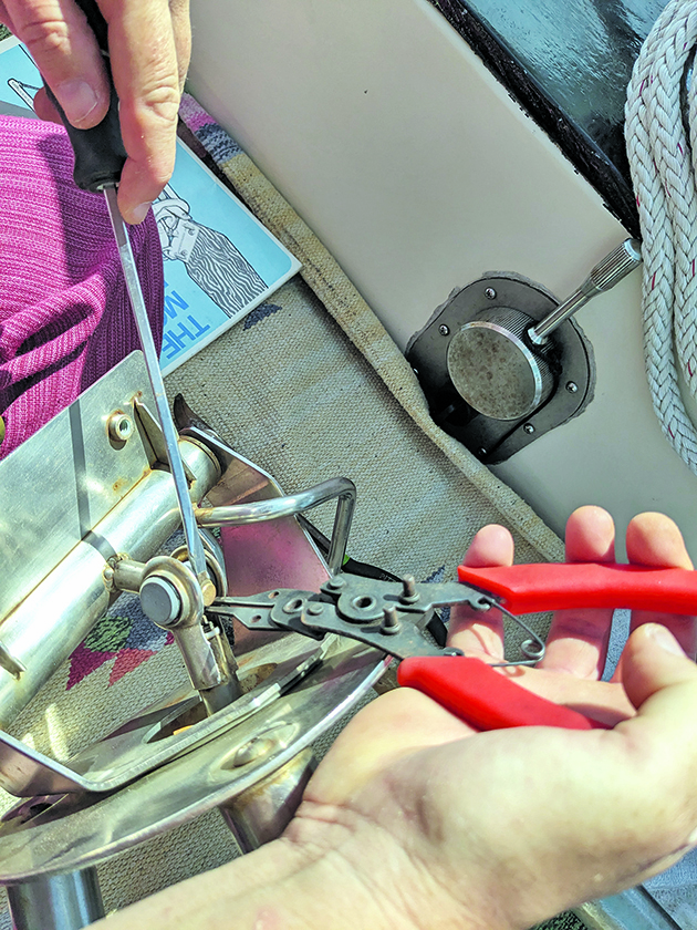 A person removing an actuator shaft from a Monitor wind vane