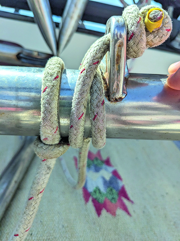 Half hitches tied onto metal tubing on a boat