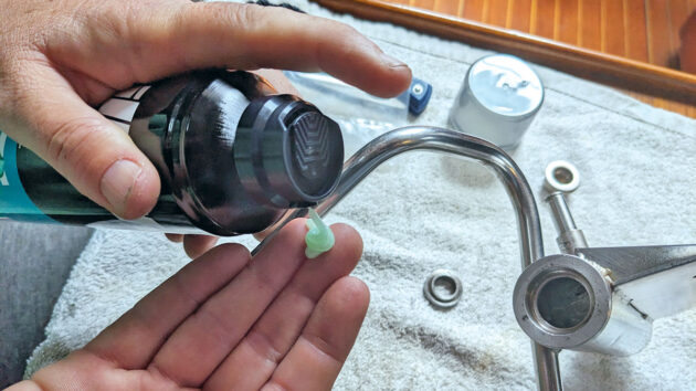 A woman using shaving cream to sort out ball bearings