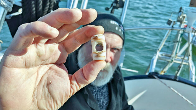 A man holding a warped bearing