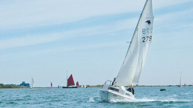 A SeaHawk 17 sailing along the coast