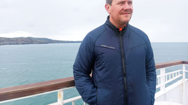 A man wearing a Henri Lloyd Smart Therm jacket on a ferry