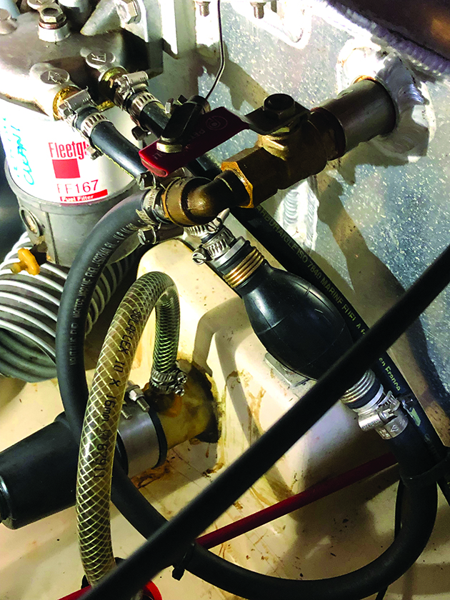 A hand pump installed to make bleeding the fuel system on a boat engine easier