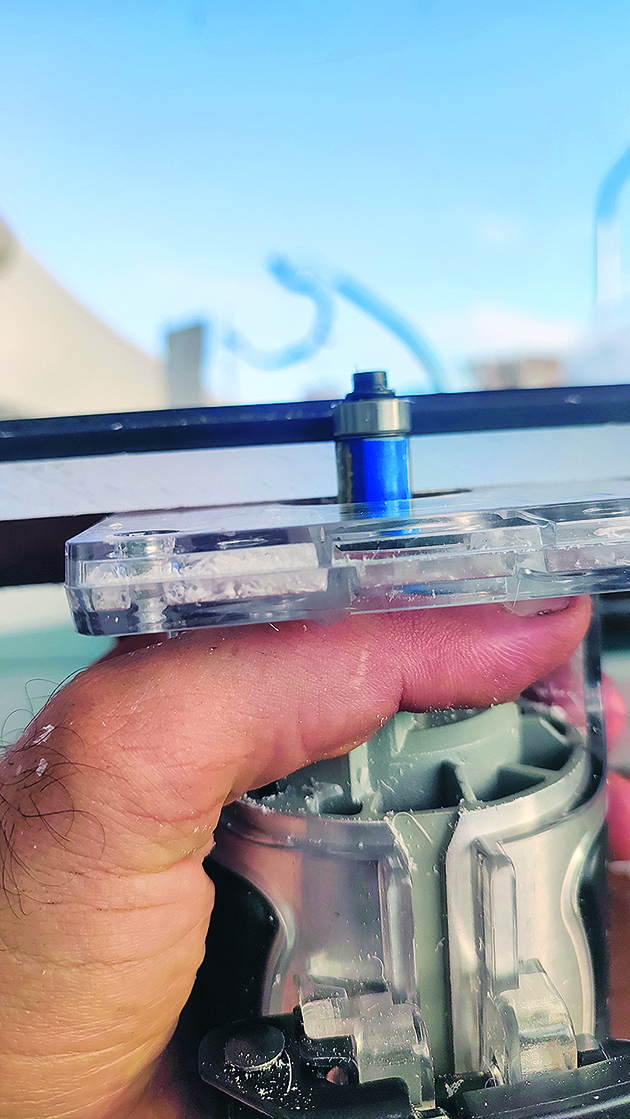 A trimming tool to router around the edge of a hatch during boat hatch replacement